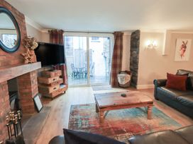 A living room with a coffee table and television at Chapel Hill Cottage in Ambleside