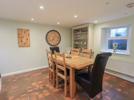 A dining room with a wooden table and chairs at Chapel Hill Cottage in Ambleside