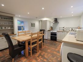 A kitchen with a dining table and appliances at Chapel Hill Cottage in Ambleside