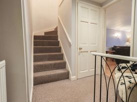 A hallway with stairs leading up at Chapel Hill Cottage in Ambleside