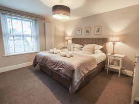 A bedroom with a bed and bedside tables at Chapel Hill Cottage Ambleside