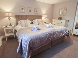 A bedroom with a bed and nightstand at Chapel Hill Cottage in Ambleside
