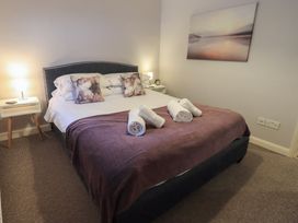 A bedroom with a bed and bedside tables at Chapel Hill Cottage in Ambleside