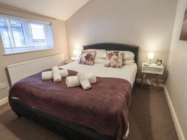 A bedroom with a double bed and nightstand at Chapel Hill Cottage in Ambleside