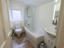 A bathroom with a bathtub and a shower at Chapel Hill Cottage in Ambleside