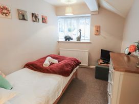 A bedroom with a bed and television at Chapel Hill Cottage in Ambleside