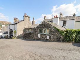 A view of stone houses with chimneys on a road at Chapel Hill Cottage in Ambleside