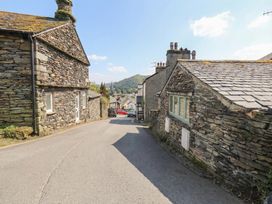 A road between stone buildings at Chapel Hill Cottage in Ambleside