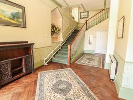 A hallway with a staircase and sideboard at South View in Keswick