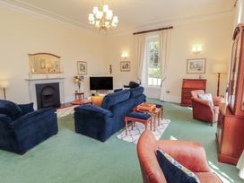 A living room with sofas and a television at South View in Keswick
