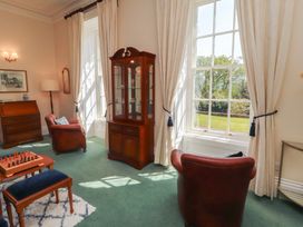 A living room with a glass cabinet and chess set at South View in Keswick
