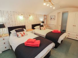 A bedroom with two beds and nightstands at South View in Keswick