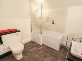 A bathroom with a bathtub, shower, toilet and sink at South View in Keswick