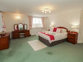 A bedroom with a bed and dressing table at South View in Keswick