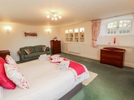 A bedroom with a bed and sofa at South View in Keswick