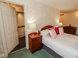 A bedroom with a bed and a nightstand at South View in Keswick