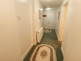 A hallway with a radiator and framed pictures at South View in Keswick