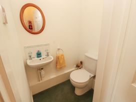 A bathroom with a sink, toilet, and mirror at South View in Keswick