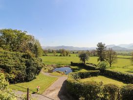 A garden with a pond and hedges at South View in Keswick