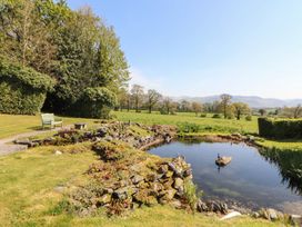 A garden with a pond and bench at South View in Keswick
