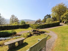 A garden with a pathway and bench at South View in Keswick