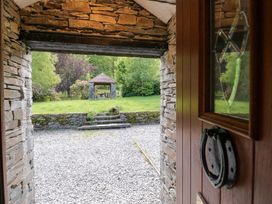 A view from a doorway showing a gazebo and grass area at Elterwater Lodge in Elterwater