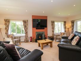 A living room with sofas and a fireplace at Elterwater Lodge in Elterwater