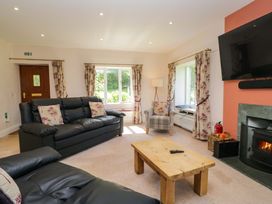 A living room with a sofa and fireplace at Elterwater Lodge in Elterwater