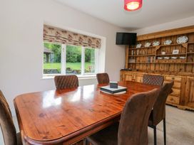 A dining room with a wooden table and chairs at Elterwater Lodge in Elterwater