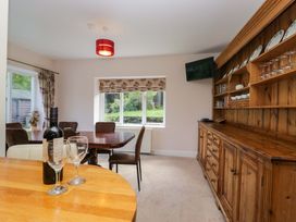 A dining room with a table and chairs at Elterwater Lodge in Elterwater
