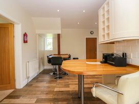 A kitchen with a countertop and stools at Elterwater Lodge in Elterwater