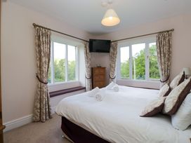 A bedroom with a bed and window view at Elterwater Lodge Elterwater