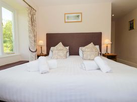 A bedroom with a bed and pillows at Elterwater Lodge in Elterwater