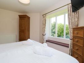 A bedroom with a double bed and wardrobe at Elterwater Lodge in Elterwater