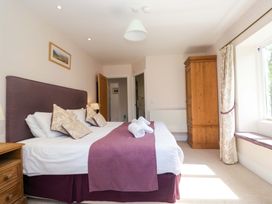 A bedroom with a double bed and wardrobe at Elterwater Lodge in Elterwater