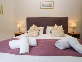 A bedroom with a bed and pillows at Elterwater Lodge in Elterwater