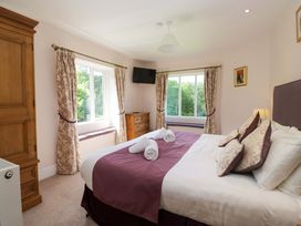 A bedroom with a bed and window at Elterwater Lodge in Elterwater