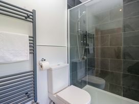 A bathroom with a toilet and shower at Elterwater Lodge in Elterwater