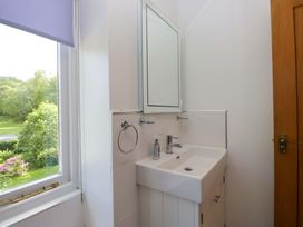 A sink with a mirror in a bathroom at Elterwater Lodge in Elterwater