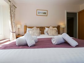 A bedroom with a bed and pillows at Elterwater Lodge in Elterwater