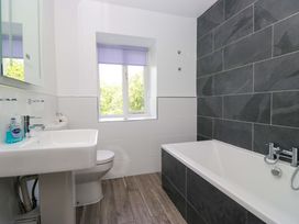 A bathroom with a sink, toilet, and bathtub at Elterwater Lodge in Elterwater