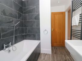A bathroom with a bathtub and sink at Elterwater Lodge in Elterwater