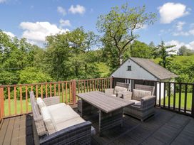 A deck with seating and a table at Elterwater Lodge in Elterwater