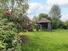 A garden with a gazebo and flowers at Elterwater Lodge in Elterwater