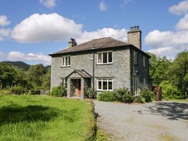 A house with a driveway and garden at Elterwater Lodge in Elterwater