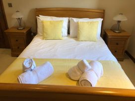 A bedroom with a bed and bedside tables at Dancing Beck Cottage in Millbeck