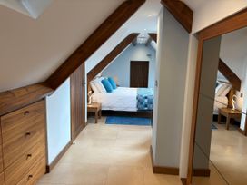 A bedroom with a bed and bedside table at Dancing Beck Cottage in Millbeck