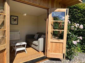 A snug with a sofa, table and framed picture at Grisedale View in Keswick