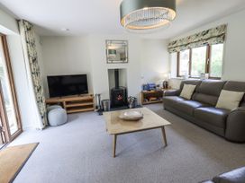 A living room with a fireplace and television at No 7 Ambleside