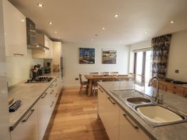 A kitchen with table and chairs at No 7 in Ambleside